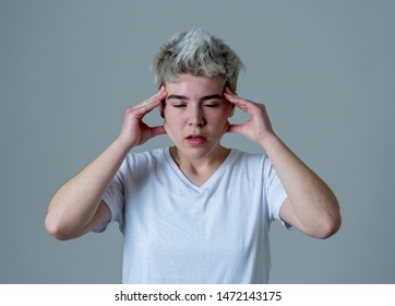 Portrait of a young transgender teen looking worried and thoughtful suffering from migraines and emotional pain. People Diversity gender identity and Depression in adolescent and health care concept.