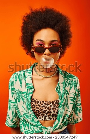 Similar – Image, Stock Photo Portrait of young bold African American female in long zipper coat confidently looking at camera standing on orange background