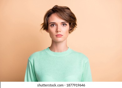 Portrait of young unhappy upset sad serious girl wear turquoise sweater look camera isolated on beige color background - Shutterstock ID 1877919646