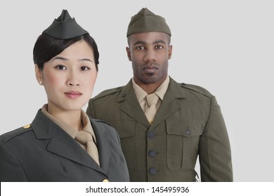 Portrait of young US military officers in uniform over gray background