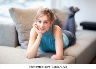 Portrait Of Young Woman With Amputee Arm Lying On Couch