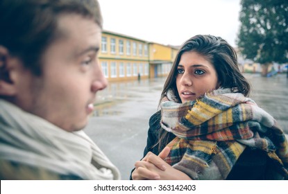 Portrait Of Young Woman Asking Apologize To Offended Man After A Hard Quarrel Outdoors. Couple Relationships And Problems Concept.