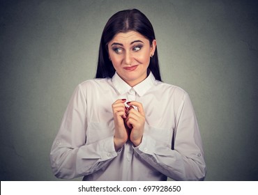 Portrait Of A Young Woman In Awkward Situation, Playing Nervously With Hands. 