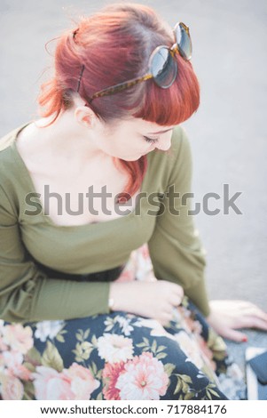 portrait young woman beautiful posing outdoor looking down - attitude, positive, influencer concept
