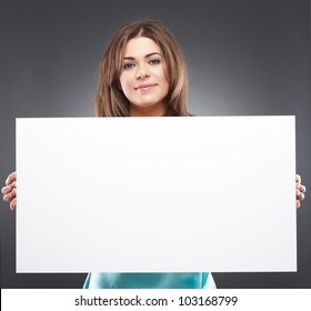 Portrait of young woman with blank white board on gray isolated