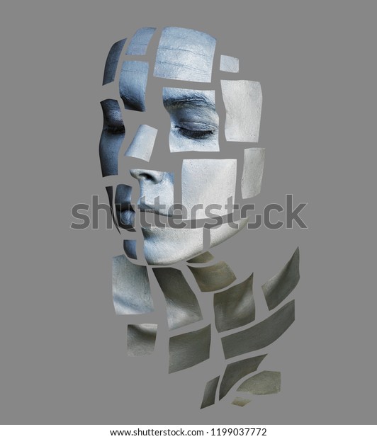 Portrait of a young woman with bold glowing\
makeup posing in the studio. Shape of metallic silver squares on\
woman face. Isolated on gray\
background.