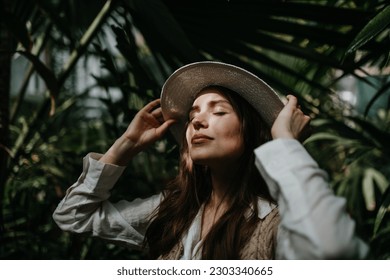 Portrait of young woman in botanical garden. - Powered by Shutterstock