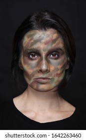 Portrait Of Young Woman With Camouflage Face Paint