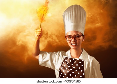 Portrait Of Young Woman Chef With Fire Around Her