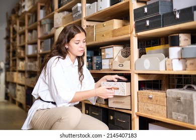 Portrait Of Young Woman Choosing Jewelry Storage Container At Store Of Household Goods