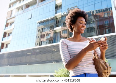 Portrait Of A Young Woman In The City With Cell Phone