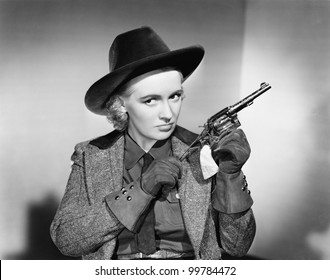 Portrait Of A Young Woman Cleaning A Handgun