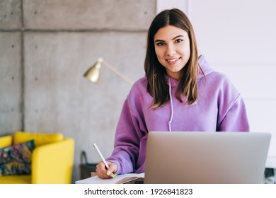 Portrait Of Young Woman College Student Studying With Laptop, Distantly Preparing For Test Exam, Writing Essay Doing Homework At Home, Distantly Education Concept.