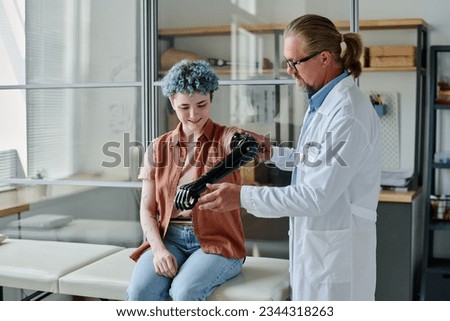 Portrait of young woman with colored hair smiling during prosthetic fitting in orthology clinic, copy space