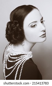 Portrait of young woman with dark hair in retro style.