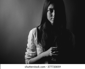 Portrait Of Young Woman In Darkness. High Contrast , Black And White.