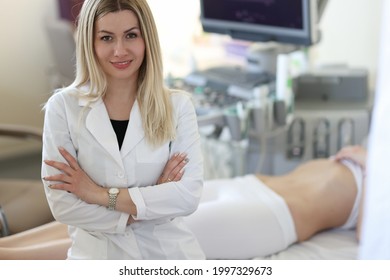 Portrait Of Young Woman Doctor Sonographer In Medical Office With Patient