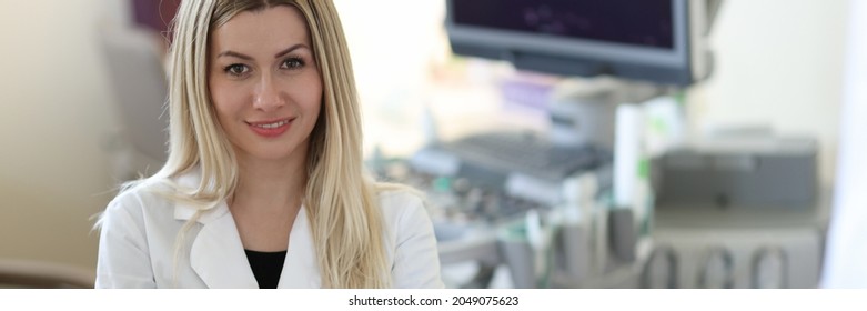 Portrait Of Young Woman Doctor Sonographer In Medical Office With Patient