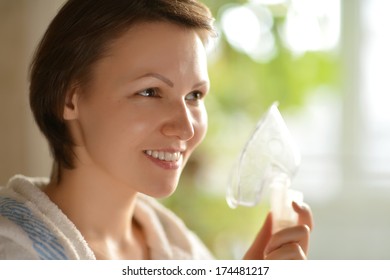 Portrait Of A Young Woman Is Doing Inhalation At Home