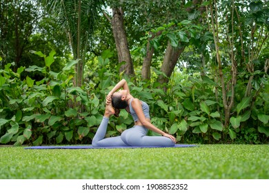 Portrait of a young woman doing yoga in the garden for a workout. Concept of lifestyle fitness and healthy. Asian women are practicing yoga in the park. - Powered by Shutterstock