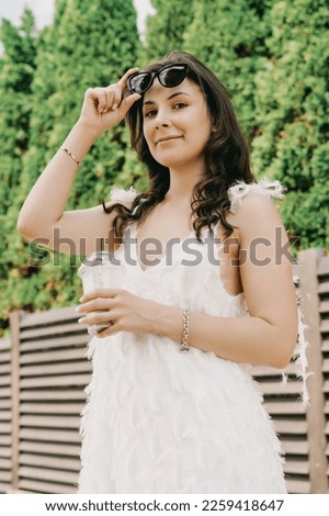 Similar – Young woman with closed eyes laughing over nature background