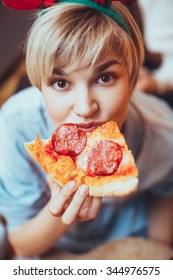 Portrait Of Young Woman Eating Pizza