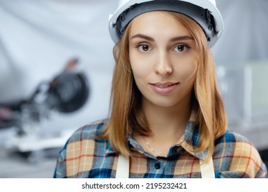 Portrait Young Woman Engineer In Hardhat. University Graduate Trainee Worker Of Modern Manufacturing Factory Blue Background.