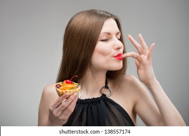 Portrait of young woman enjoying the cake