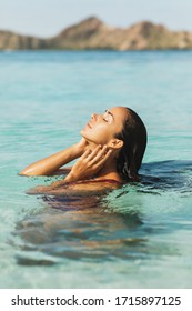 Portrait Of Young Woman Enjoying And Relaxing In Clean Transparent Ocean Water. Leisure, Carefree And Vacation Concept. Wanderlust Travel In Asia.