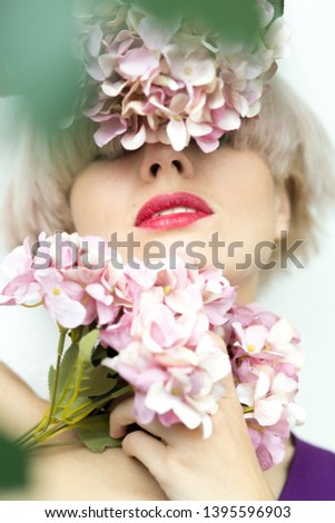 Similar – Young blonde woman posing with a huge daisy