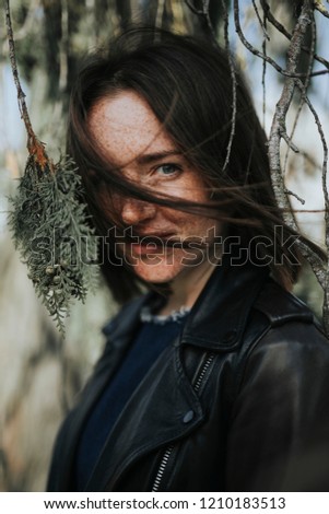 Similar – ein Mädchen mit langen Haaren und blauen Augen in den Bergen, das mit einer Kapuze lächelt