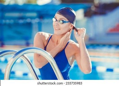 Portrait Of A Young Woman In Goggles And Swimming Cap