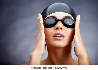 Portrait Of A Young Woman In Goggles And Swimming Cap