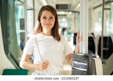 Portrait of young woman going to work by bus or trolley at early morning