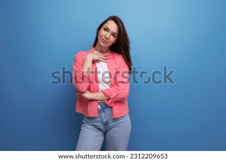 portrait of a young woman with hair below her shoulders in jeans and a shirt