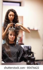 Portrait of a young woman having a haircut looking away from the camera