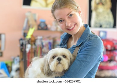 Portrait Of Young Woman And Her Dog In Pet Store