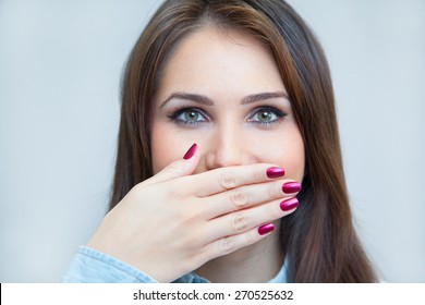 Portrait Of A Young Woman Hiding Her Mouth With A Hand