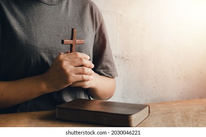 A Portrait Of A Young Woman Holding A Bible Tightly To Her Chest. Ready To Hold The Cross Christianity Is Ready To Show Love For God.