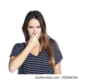 Portrait Of A Young Woman Holding Her Nose Because Of A Bad Smell. Isolated On White Background