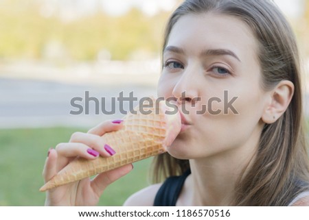 portrait of a young woman with ice cream in park