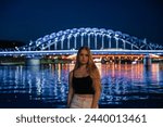 Portrait of a Young Woman with the Illuminated Jozef Pilsudski Bridge, Krakow
