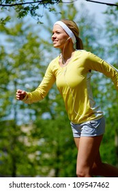 Portrait Of A Young Woman Jogging With A Walkman