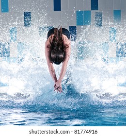 Portrait Of A Young Woman Jumping In Swimming Pool