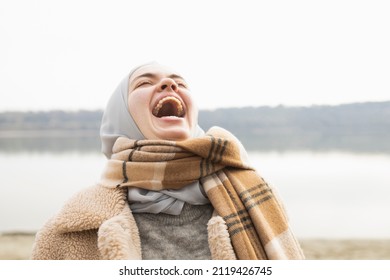 Portrait Of A Young Woman Laughing Hysterically