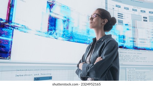 Portrait of Young Woman Looking at Big Digital Screens Glitching While Displaying Code Lines. Worried Professional Programmer Trying to Fix a Bug, Dealing with Crashing System, Thinking of Solutions