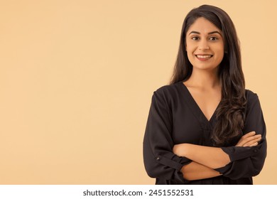 Portrait of a young woman looking at the camera with arms crossed - Powered by Shutterstock