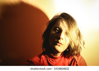 Portrait of a young woman looking into the camera. Overexposed photo