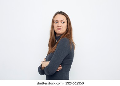 Portrait Of Young Woman Looking Mad Over Shoulder
