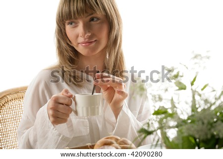 Portrait of young woman mixing tea